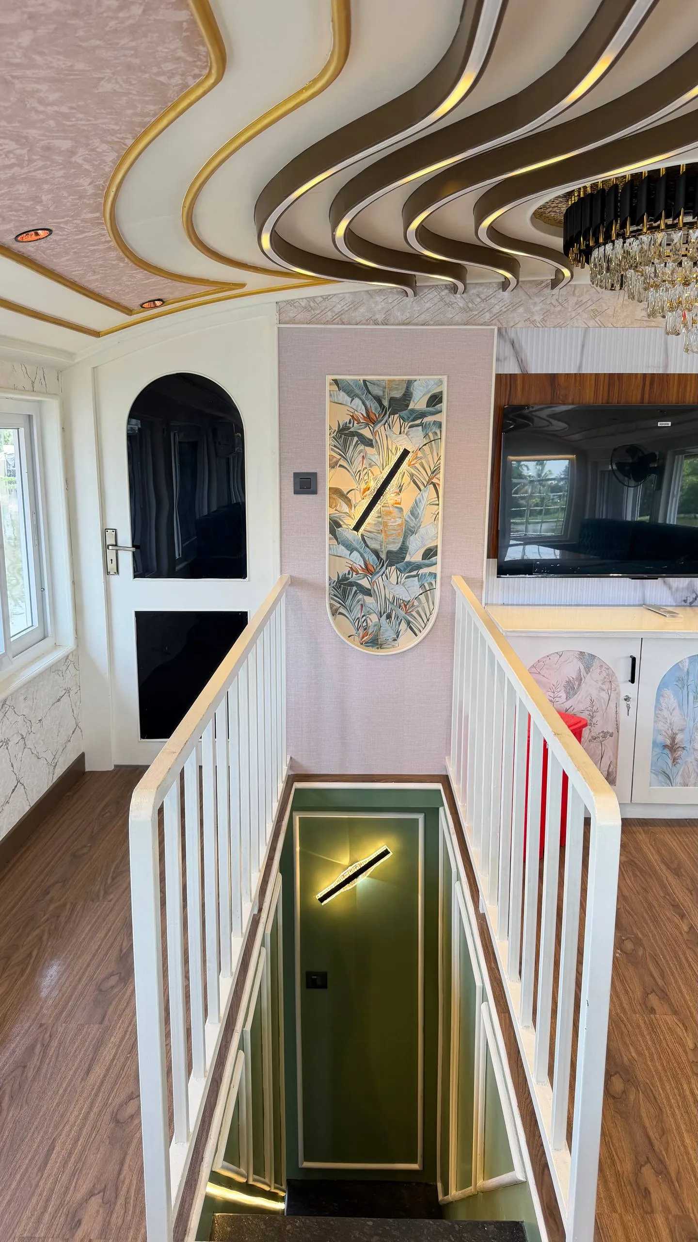 Stunning wooden spiral staircase leading to the upper deck of Mahadeva houseboat
