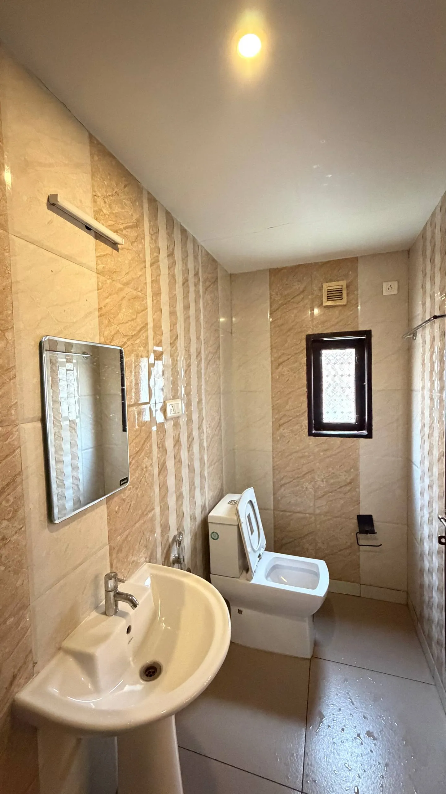 Second tidy en-suite bathroom layout for guests on Vinayaka